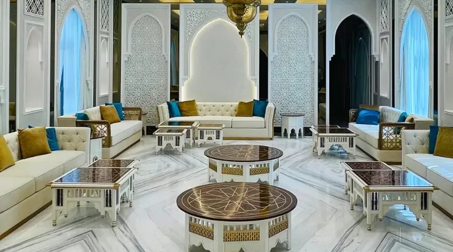 Islamic majlis design with traditional carved furniture, mashrabiya panels, and marble flooring in a luxury interior