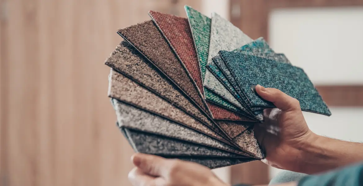  A selection of carpet tile samples in various colors and textures, ideal for custom office carpet tiles in Dubai.