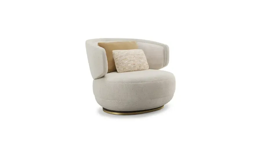 Luxury round accent chair with plush light fabric, curved back, gold base, and decorative pillows, perfect for a modern bedroom or lounge.