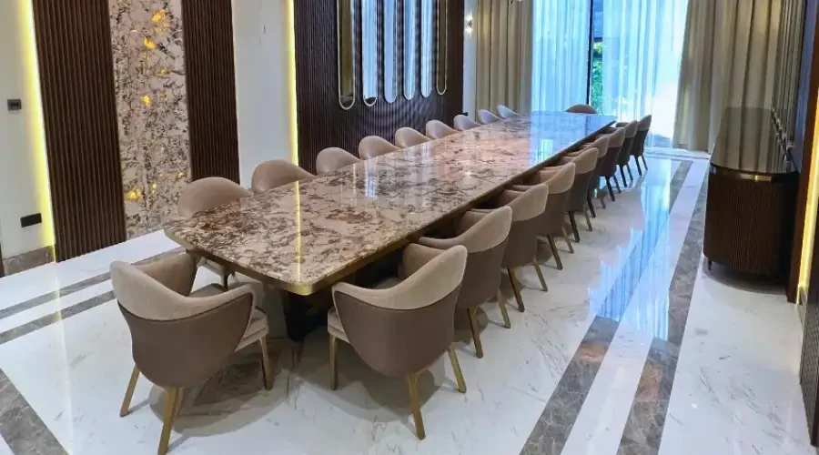 Custom extra-long dining table and velvet chairs as part of bespoke modern dining room design furniture in a luxury formal dining room