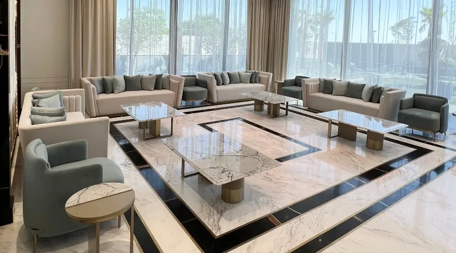 Luxury modern majlis design with custom sofas, marble coffee tables, and elegant floor inlay, crafted for upscale residential interiors in the UAE