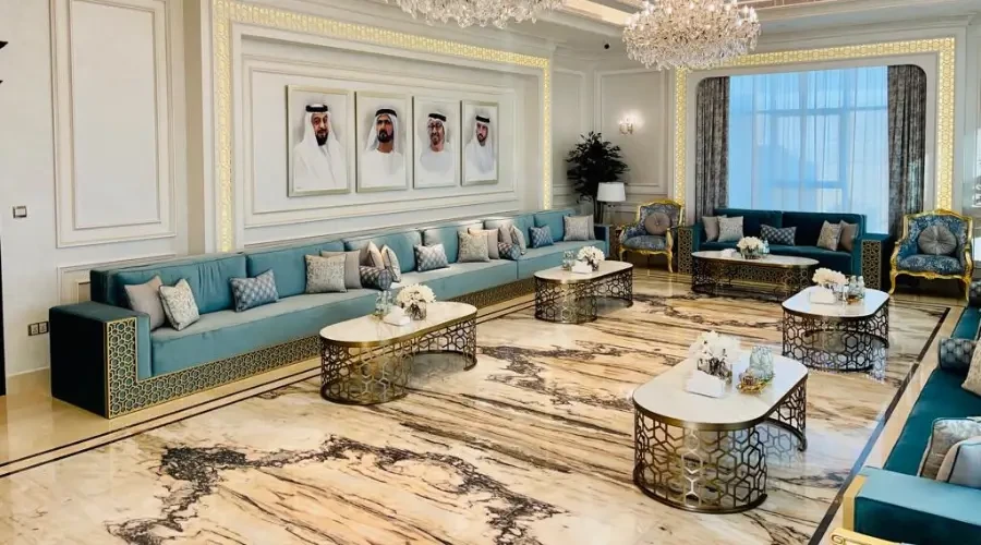 Moroccan majlis design with custom seating, arabesque metal tables, and marble flooring in a luxury interior