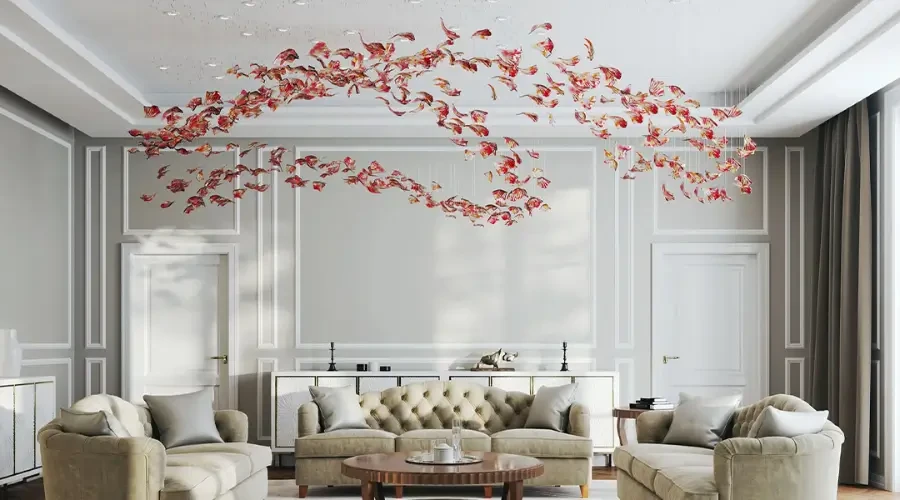 uxury living room with tufted sofas and artistic ceiling chandelier featuring red sculptural leaves